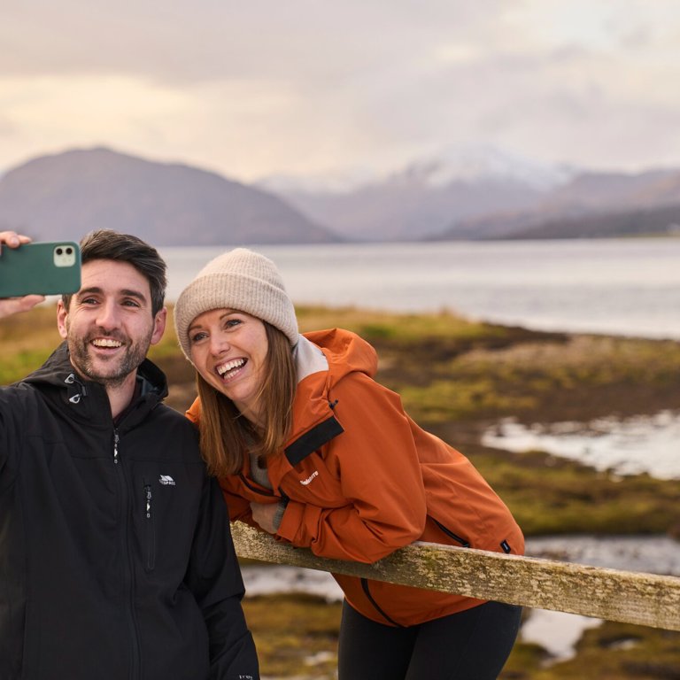 Couple taking selfie outside Ballachulish Hotel